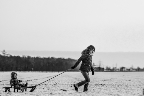 mother-child-sledding-in-winter